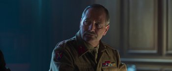 Movie still from “Churchill” (2017), directed by Jonathan Teplitzky – An older man in a military uniform looking to his left; Close Up shot, Low angle