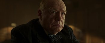 Movie still from “Churchill” (2017), directed by Jonathan Teplitzky – An older man with a frowning look on his face; Close Up shot, Low angle