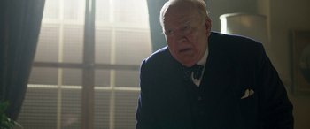 Movie still from “Churchill” (2017), directed by Jonathan Teplitzky – An older man in a suit and tie looking to his left; Close Up shot, Low angle