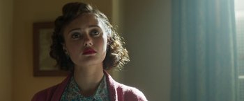 Movie still from “Churchill” (2017), directed by Jonathan Teplitzky – A young woman with curly brown hair wearing a floral shirt; Close Up shot, Over the shoulder angle
