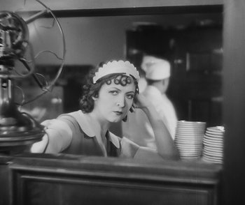 Movie still from “City Girl” (1930), directed by F.W. Murnau – A woman sitting at a counter in a restaurant; Medium shot, High angle
