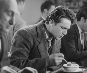 Movie still from “City Girl” (1930), directed by F.W. Murnau – Black and white photograph of a man eating a bowl of soup; Medium shot, Over the shoulder angle