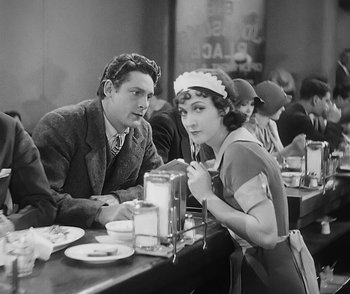 Movie still from “City Girl” (1930), directed by F.W. Murnau – A man and a woman sitting at a table in a restaurant; Medium shot, Over the shoulder angle