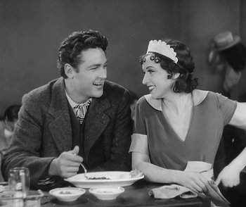 Movie still from “City Girl” (1930), directed by F.W. Murnau – A man and a woman sitting at a dinner table; Medium shot, High angle