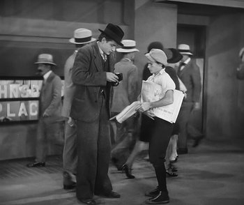 Movie still from “City Girl” (1930), directed by F.W. Murnau – A man and a woman are talking to each other; Wide shot, High angle