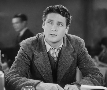 Movie still from “City Girl” (1930), directed by F.W. Murnau – A black and white photo of a man sitting at a table; Close Up shot, High angle