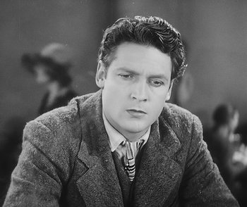 Movie still from “City Girl” (1930), directed by F.W. Murnau – Black and white photograph of a man in a suit and tie; Close Up shot, Low angle