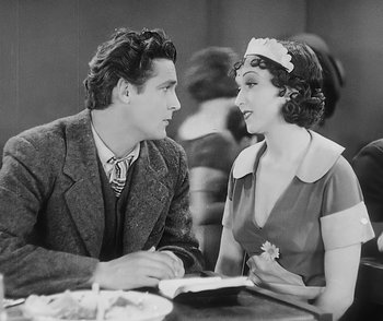 Movie still from “City Girl” (1930), directed by F.W. Murnau – A man and a woman sitting at a dinner table; Medium shot, High angle