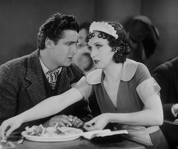 Movie still from “City Girl” (1930), directed by F.W. Murnau – A man and a woman sitting at a dinner table; Medium shot, Over the shoulder angle