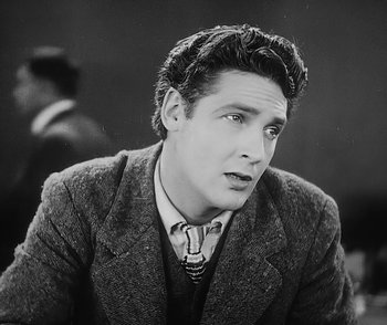 Movie still from “City Girl” (1930), directed by F.W. Murnau – Black and white photograph of a man in a suit and tie; Close Up shot, High angle