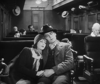 Movie still from “City Girl” (1930), directed by F.W. Murnau – A man and a woman sitting next to each other on a bench; Medium shot, High angle