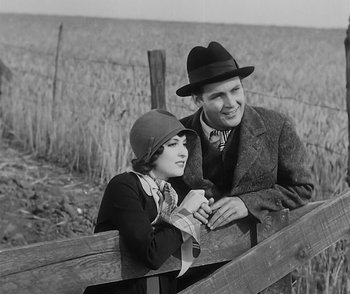 Movie still from “City Girl” (1930), directed by F.W. Murnau – A man and a woman leaning on a fence; Medium shot, High angle