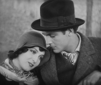 Movie still from “City Girl” (1930), directed by F.W. Murnau – A man and a woman wearing hats and scarves; Close Up shot, High angle