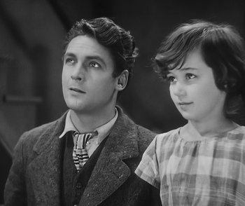 Movie still from “City Girl” (1930), directed by F.W. Murnau – A man and a woman standing next to each other; Medium shot, High angle