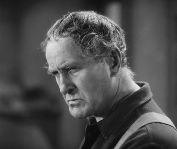 Movie still from “City Girl” (1930), directed by F.W. Murnau – An older man is looking into the distance; Close Up shot, Over the shoulder angle