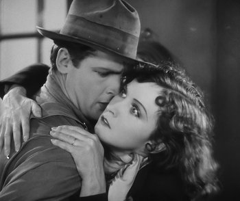 Movie still from “City Girl” (1930), directed by F.W. Murnau – A man and a woman embracing each other in a black and white photo; Close Up shot, Overhead angle