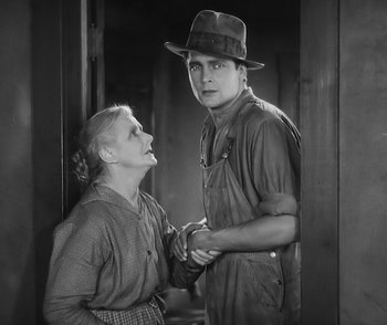 Movie still from “City Girl” (1930), directed by F.W. Murnau – An old photo of a man and a woman; Medium shot, Low angle