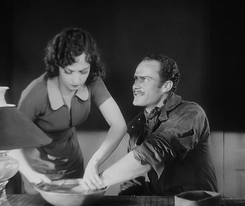 Movie still from “City Girl” (1930), directed by F.W. Murnau – A man and a woman are preparing a meal together; Medium shot, High angle