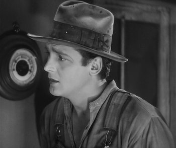 Movie still from “City Girl” (1930), directed by F.W. Murnau – A black and white photo of a man wearing a hat; Close Up shot, Low angle