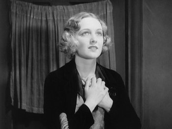 Movie still from “City Lights” (1931), directed by Charles Chaplin – An old photo of a woman in a black jacket; Close Up shot, Low angle