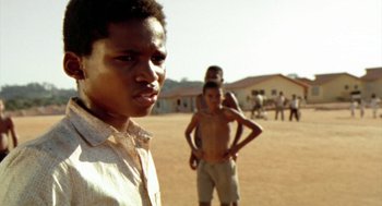 Movie still from “City of God” (2002), directed by Kátia Lund – Two young men standing in a dirt field; Close Up shot, Low angle