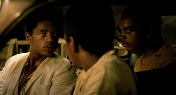 Movie still from “City of God” (2002), directed by Kátia Lund – A group of men sitting next to each other in front of a mirror; Close Up shot, Over the shoulder angle