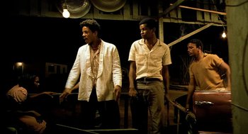 Movie still from “City of God” (2002), directed by Kátia Lund – A couple of men standing next to each other on a stage; Medium shot, Low angle