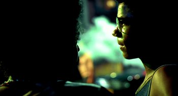 Movie still from “City of God” (2002), directed by Kátia Lund – Two people are talking to each other in the dark; Close Up shot, Over the shoulder angle