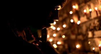 Movie still from “City of God” (2002), directed by Kátia Lund – A man is looking at the lights in the background; Extreme Close Up shot, Low angle