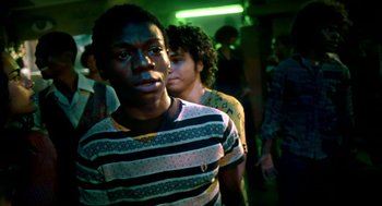 Movie still from “City of God” (2002), directed by Kátia Lund – Two young men standing next to each other in a room; Close Up shot, Over the shoulder angle