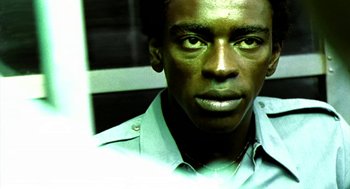 Movie still from “City of God” (2002), directed by Kátia Lund – A person wearing a green shirt; Close Up shot, Low angle