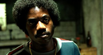 Movie still from “City of God” (2002), directed by Kátia Lund – A person wearing a jacket; Close Up shot, Low angle