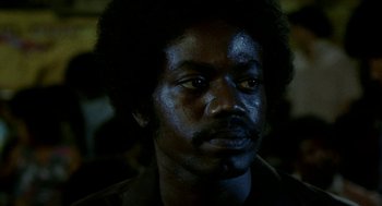 Movie still from “City of God” (2002), directed by Kátia Lund – A person wearing a black shirt; Close Up shot, Low angle