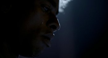 Movie still from “City of God” (2002), directed by Kátia Lund – A man's face in the dark; Extreme Close Up shot, Low angle