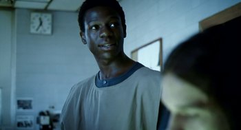 Movie still from “City of God” (2002), directed by Kátia Lund – A young man is standing in front of a mirror; Close Up shot, Over the shoulder angle