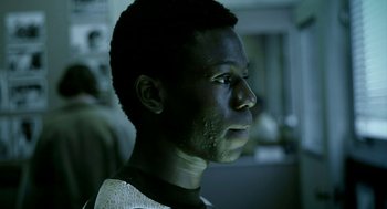 Movie still from “City of God” (2002), directed by Kátia Lund – A young man is looking into the distance; Close Up shot, Low angle