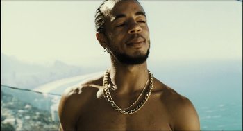 Movie still from “City of Men” (2007), directed by Paulo Morelli – A man with a beard is wearing a gold necklace; Close Up shot, Low angle