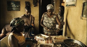 Movie still from “City of Men” (2007), directed by Paulo Morelli – A group of people standing around a table with food on top of it; Medium shot, High angle