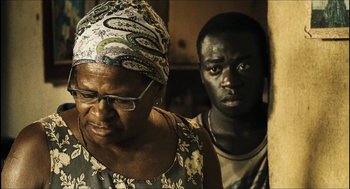 Movie still from “City of Men” (2007), directed by Paulo Morelli – A man and a woman standing next to each other in a room; Close Up shot, Over the shoulder angle