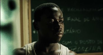 Movie still from “City of Men” (2007), directed by Paulo Morelli – A young man is looking into the distance; Close Up shot, Over the shoulder angle