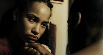 Movie still from “City of Men” (2007), directed by Paulo Morelli – A woman sitting in front of a mirror with her hand on her chin; Close Up shot, Over the shoulder angle