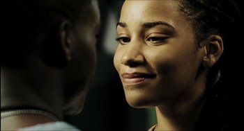 Movie still from “City of Men” (2007), directed by Paulo Morelli – A woman's face with a man in the background; Close Up shot, Over the shoulder angle