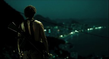 Movie still from “City of Men” (2007), directed by Paulo Morelli – A man standing on top of a hill at night; Medium shot, Low angle