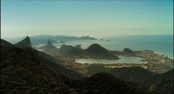 Movie still from “City of Men” (2007), directed by Paulo Morelli – A view of a large body of water with mountains in the background; Extreme Wide shot, High angle