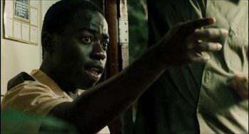 Movie still from “City of Men” (2007), directed by Paulo Morelli – A young man is pointing at something in the dark; Close Up shot, Low angle