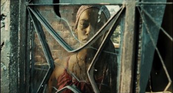 Movie still from “City of Men” (2007), directed by Paulo Morelli – A woman standing in front of a broken glass window; Close Up shot, Low angle