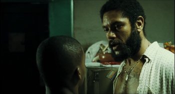 Movie still from “City of Men” (2007), directed by Paulo Morelli – A man with a beard is talking to another man; Close Up shot, Over the shoulder angle
