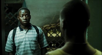 Movie still from “City of Men” (2007), directed by Paulo Morelli – A man standing next to another man in front of a wall; Close Up shot, Over the shoulder angle