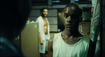 Movie still from “City of Men” (2007), directed by Paulo Morelli – A man standing next to another man in a room; Close Up shot, Low angle
