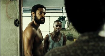 Movie still from “City of Men” (2007), directed by Paulo Morelli – Two men standing next to each other in front of a bathroom mirror; Medium shot, Low angle